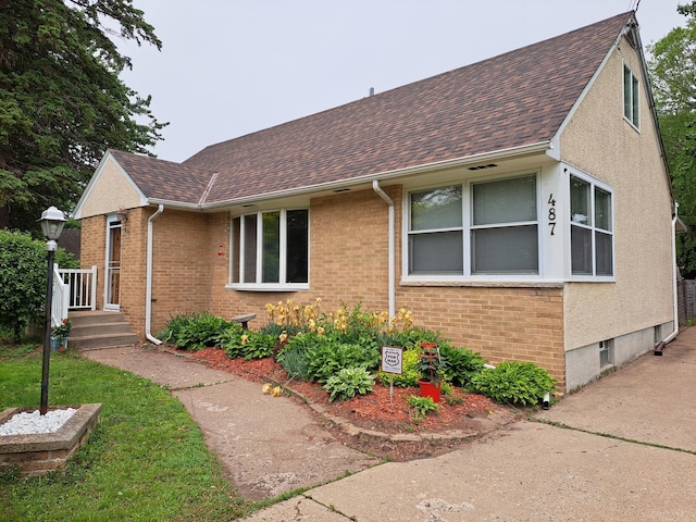487 Roselawn Ave E, Maplewood, MN 55117 - view of side of property featuring brick siding and roof with shingles