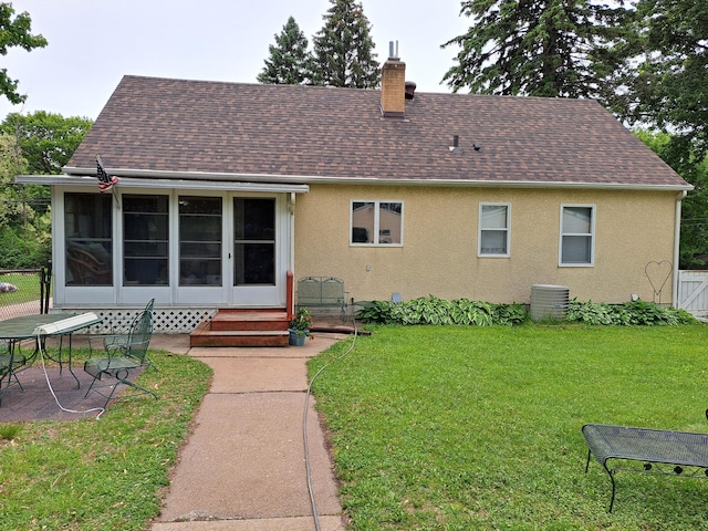 487 Roselawn Ave E, Maplewood, MN 55117 - back of house with a sunroom, a chimney, stucco siding, and a shingled roof