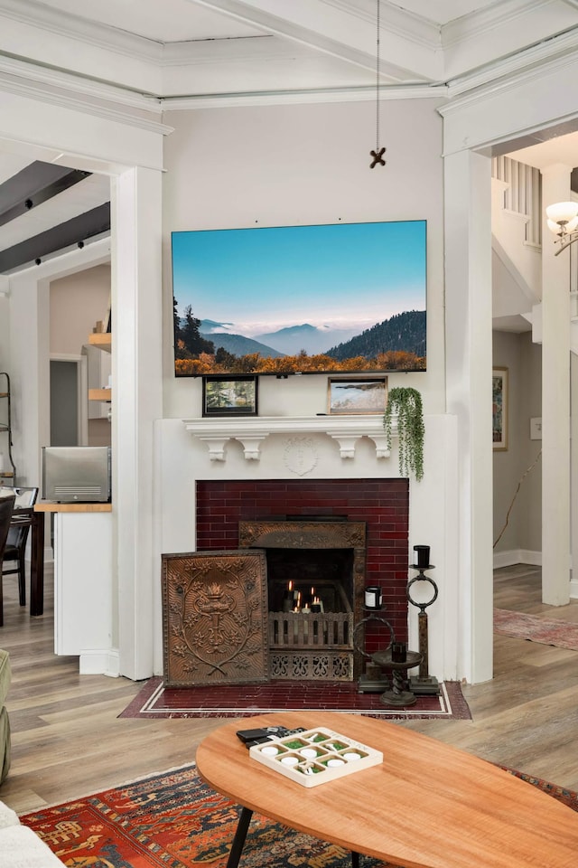 159 Western Ave S, Saint Paul, MN 55102 - living area with wood finished floors, a tiled fireplace, ornamental molding, and beam ceiling