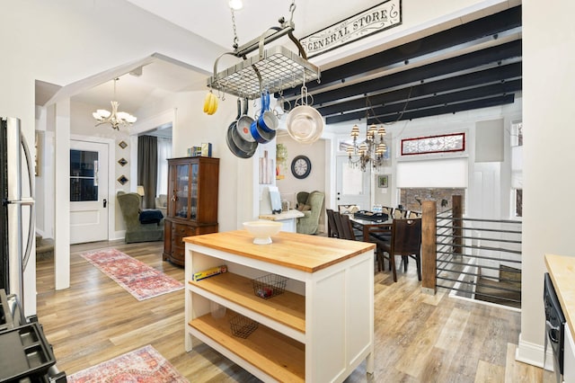 159 Western Ave S, Saint Paul, MN 55102 - kitchen with a chandelier, freestanding refrigerator, butcher block countertops, open shelves, and light wood-type flooring