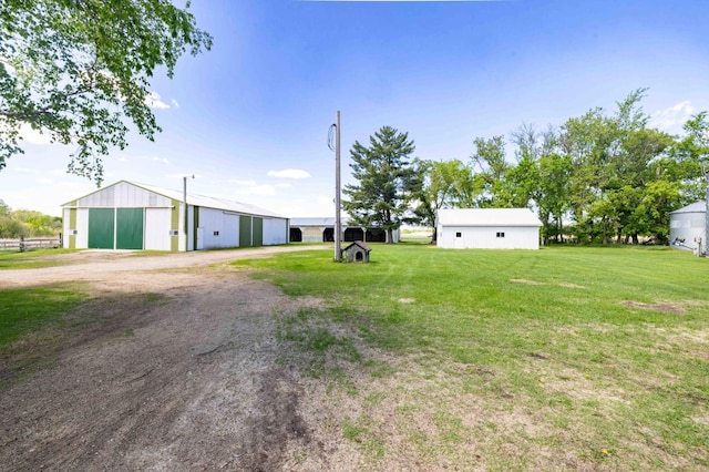 44655 Red Oak Rd, Staples, MN 56479 - view of green lawn with a pole building, an outbuilding, a detached garage, and dirt driveway
