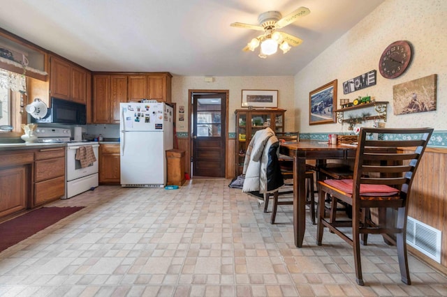 44655 Red Oak Rd, Staples, MN 56479 - kitchen with white appliances, a ceiling fan, and brown cabinets