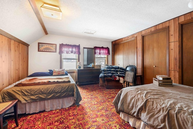 44655 Red Oak Rd, Staples, MN 56479 - bedroom featuring wooden walls, a textured ceiling, lofted ceiling, multiple closets, and carpet floors