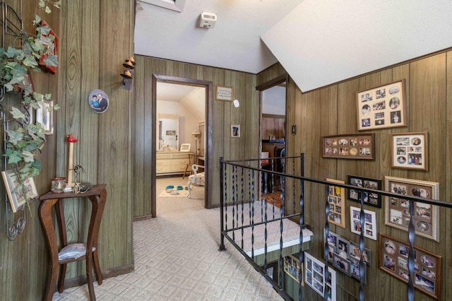 44655 Red Oak Rd, Staples, MN 56479 - hall with an upstairs landing, wood walls, carpet flooring, a textured ceiling, and baseboards