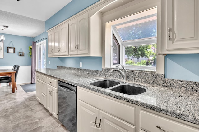 5019 Washington St NE, Columbia Heights, MN 55421 - kitchen featuring dishwasher, a textured ceiling, light stone counters, white cabinets, and wainscoting