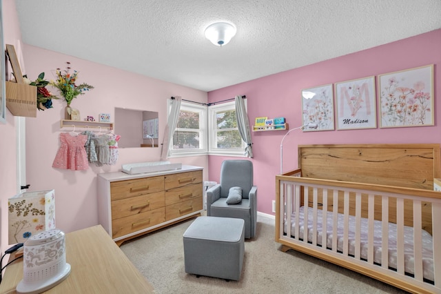 5019 Washington St NE, Columbia Heights, MN 55421 - carpeted bedroom with a textured ceiling and a nursery area