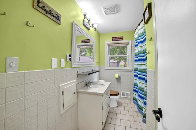 5019 Washington St NE, Columbia Heights, MN 55421 - bathroom featuring tile walls, tile patterned floors, vanity, a wainscoted wall, and a shower with curtain