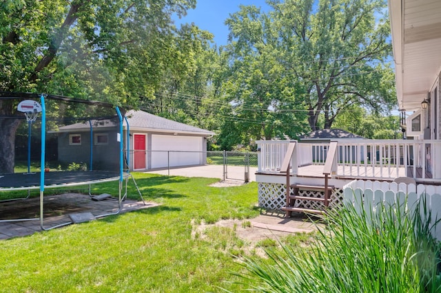 5019 Washington St NE, Columbia Heights, MN 55421 - view of yard featuring a trampoline, a garage, an outbuilding, and a deck