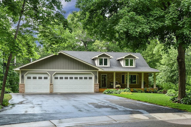 19260 81st Pl N, Maple Grove, MN 55311 - cape cod-style house with concrete driveway, brick siding, a garage, and a porch