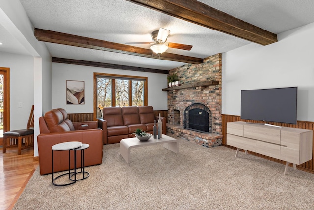 19260 81st Pl N, Maple Grove, MN 55311 - living room featuring beamed ceiling, plenty of natural light, a textured ceiling, a fireplace, and wainscoting