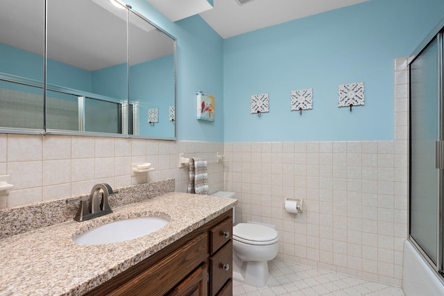 19260 81st Pl N, Maple Grove, MN 55311 - bathroom featuring toilet, tile walls, vanity, tile patterned floors, and wainscoting