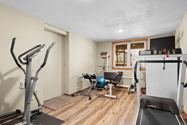 19260 81st Pl N, Maple Grove, MN 55311 - workout area featuring a textured ceiling, light wood-style flooring, and baseboards
