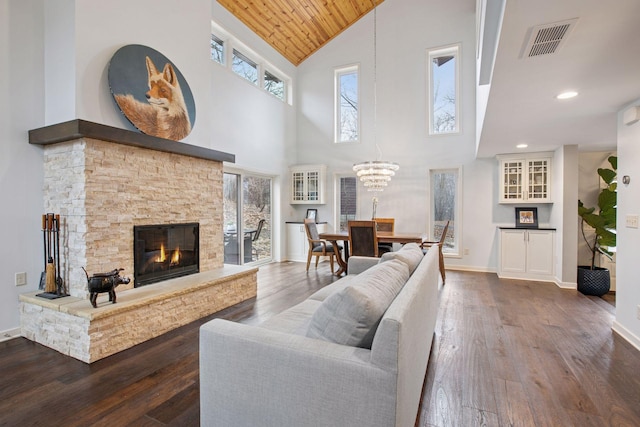 3715 Huntingdon Dr, Minnetonka, MN 55305 - living room with high vaulted ceiling, hardwood / wood-style floors, a stone fireplace, a chandelier, and wood ceiling