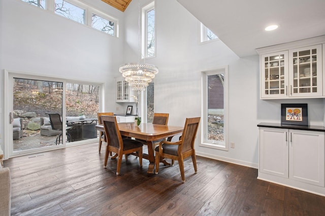3715 Huntingdon Dr, Minnetonka, MN 55305 - dining area featuring a high ceiling, a chandelier, healthy amount of natural light, dark wood-style floors, and baseboards