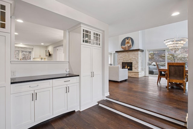 3715 Huntingdon Dr, Minnetonka, MN 55305 - bar area with dark wood-type flooring, a chandelier, a fireplace, and recessed lighting