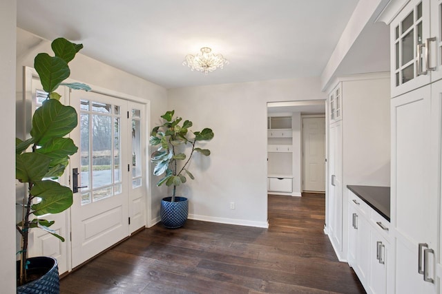 3715 Huntingdon Dr, Minnetonka, MN 55305 - entrance foyer featuring dark wood-style floors, baseboards, and a chandelier