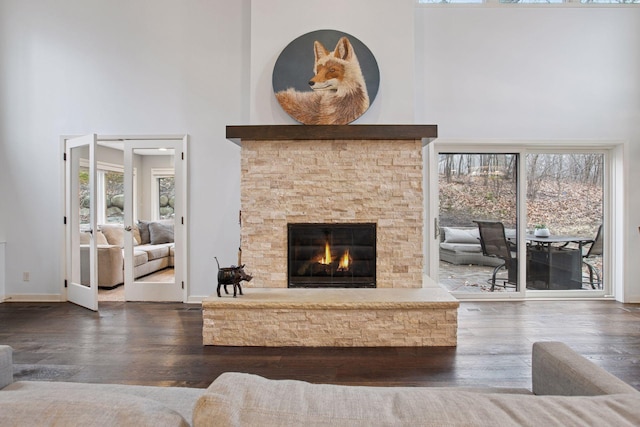 3715 Huntingdon Dr, Minnetonka, MN 55305 - living room featuring a high ceiling, healthy amount of natural light, a stone fireplace, wood finished floors, and baseboards