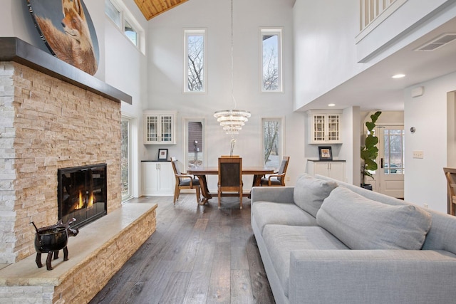3715 Huntingdon Dr, Minnetonka, MN 55305 - living area featuring high vaulted ceiling, dark wood-style flooring, a chandelier, and a fireplace
