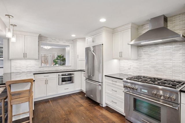 3715 Huntingdon Dr, Minnetonka, MN 55305 - kitchen with premium appliances, wall chimney exhaust hood, backsplash, white cabinetry, and recessed lighting