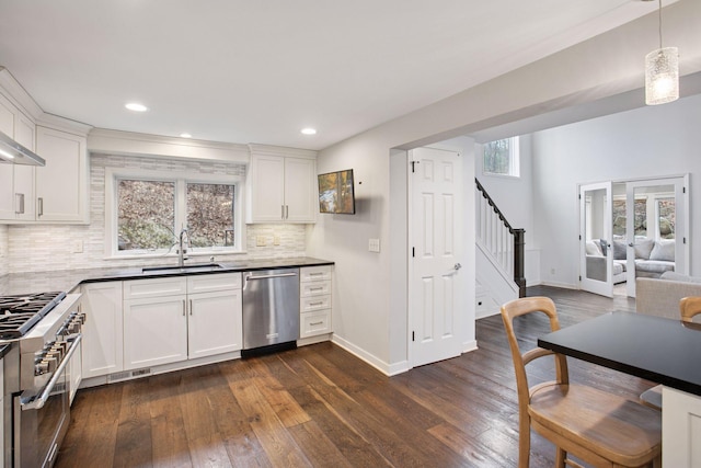 3715 Huntingdon Dr, Minnetonka, MN 55305 - kitchen featuring stainless steel appliances, a sink, backsplash, dark wood-style flooring, and recessed lighting