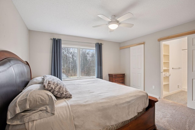 3715 Huntingdon Dr, Minnetonka, MN 55305 - bedroom with carpet flooring, a textured ceiling, a closet, ensuite bath, and ceiling fan