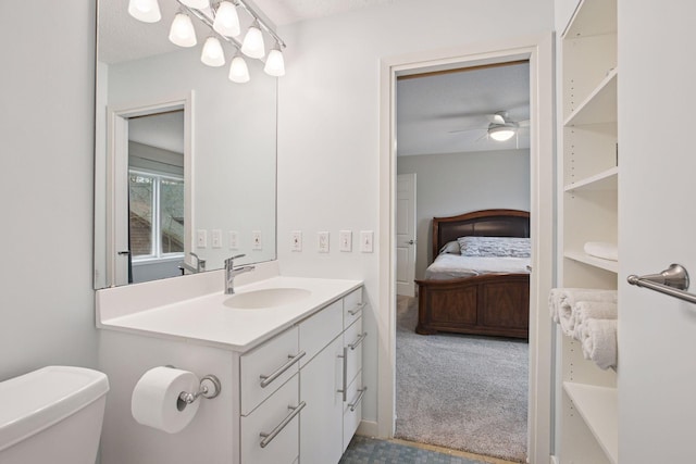 3715 Huntingdon Dr, Minnetonka, MN 55305 - bathroom with vanity, connected bathroom, toilet, and ceiling fan