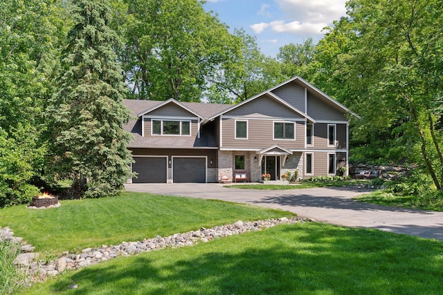 3715 Huntingdon Dr, Minnetonka, MN 55305 - view of front of property with an outdoor fire pit, a garage, asphalt driveway, stone siding, and a front yard
