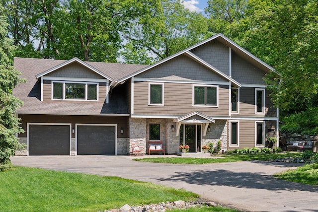 3715 Huntingdon Dr, Minnetonka, MN 55305 - view of front facade featuring an attached garage, driveway, stone siding, and roof with shingles