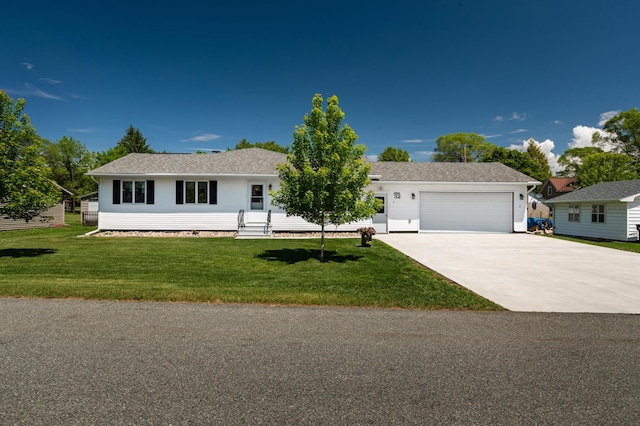 32 7th St, Buffalo City, WI 54622 - ranch-style home featuring an attached garage, concrete driveway, a front lawn, and a shingled roof
