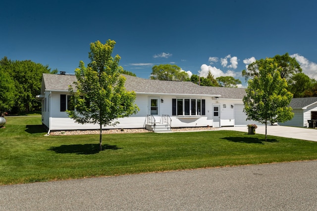 32 7th St, Buffalo City, WI 54622 - single story home featuring a garage, concrete driveway, a front yard, and roof with shingles