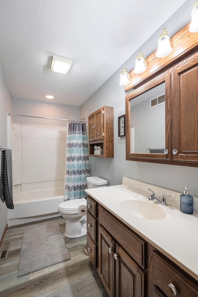 32 7th St, Buffalo City, WI 54622 - full bath featuring vanity, shower / bath combination with curtain, wood finished floors, and a textured ceiling