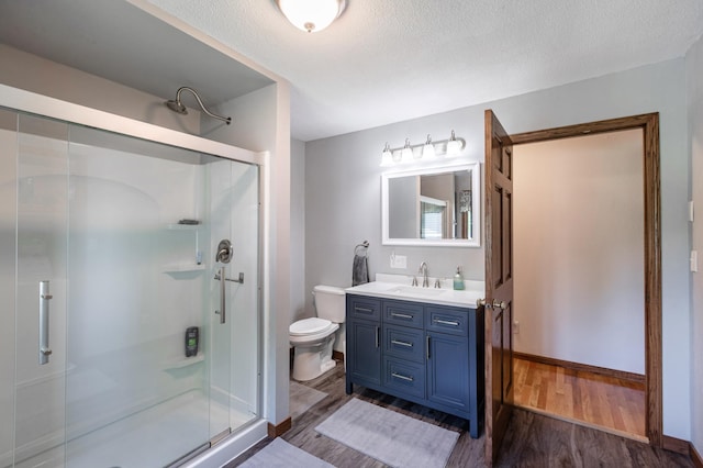 32 7th St, Buffalo City, WI 54622 - bathroom featuring a shower stall, wood finished floors, vanity, and a textured ceiling