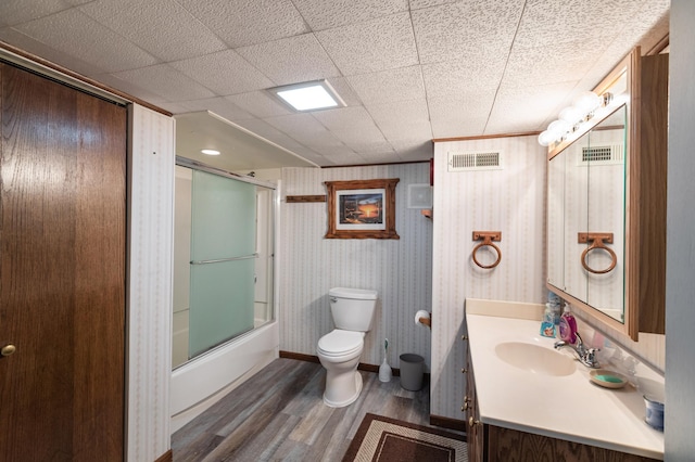 32 7th St, Buffalo City, WI 54622 - full bath featuring wood finished floors, vanity, and enclosed tub / shower combo