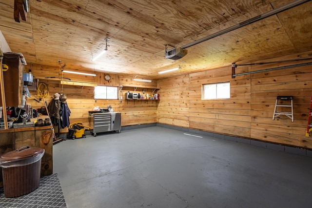 32 7th St, Buffalo City, WI 54622 - garage featuring a garage door opener, wood walls, and wood ceiling