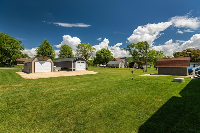 32 7th St, Buffalo City, WI 54622 - view of green lawn with a detached garage, driveway, and a storage shed