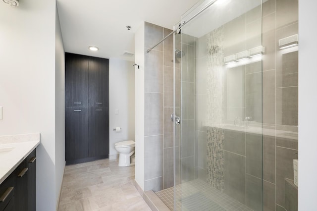 740 Portland Ave Unit 907, Minneapolis, MN 55415 - bathroom with vanity, a stall shower, toilet, and recessed lighting