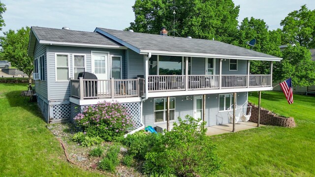 27668 Crappie Trl, Sverdrup Twp, MN 56586 - rear view of house with a lawn, roof with shingles, a wooden deck, and a patio area