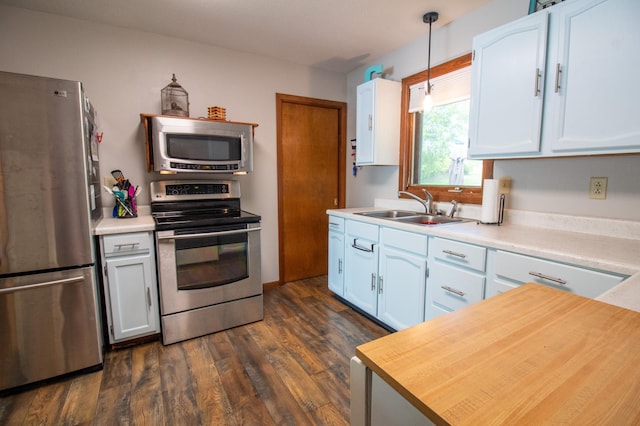 27668 Crappie Trl, Sverdrup Twp, MN 56586 - kitchen with stainless steel appliances, a sink, light countertops, dark wood-style floors, and white cabinets