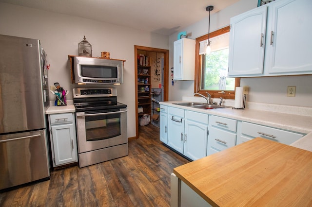 27668 Crappie Trl, Sverdrup Twp, MN 56586 - kitchen with stainless steel appliances, a sink, light countertops, dark wood-style flooring, and white cabinets
