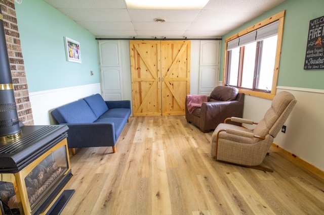 27668 Crappie Trl, Sverdrup Twp, MN 56586 - living area with a drop ceiling, light wood-style flooring, and a barn door