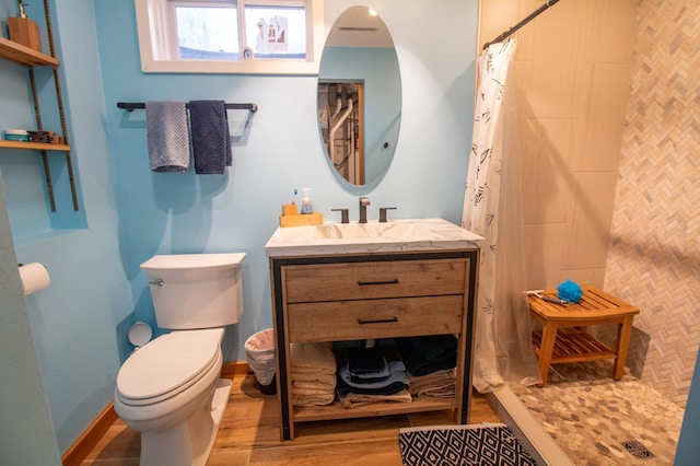 27668 Crappie Trl, Sverdrup Twp, MN 56586 - bathroom featuring toilet, vanity, a tile shower, and wood finished floors