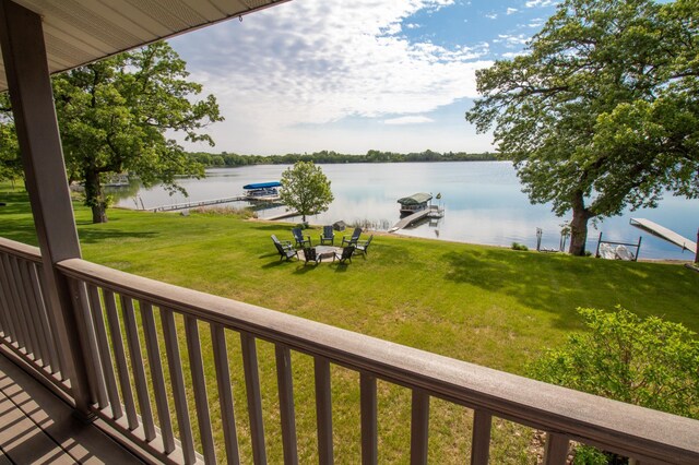 27668 Crappie Trl, Sverdrup Twp, MN 56586 - wooden deck featuring a water view, a dock, a yard, and boat lift