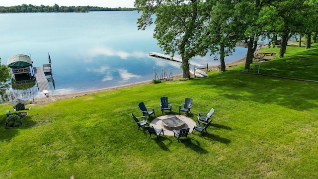 27668 Crappie Trl, Sverdrup Twp, MN 56586 - view of green lawn with a water view, a fire pit, and a boat dock