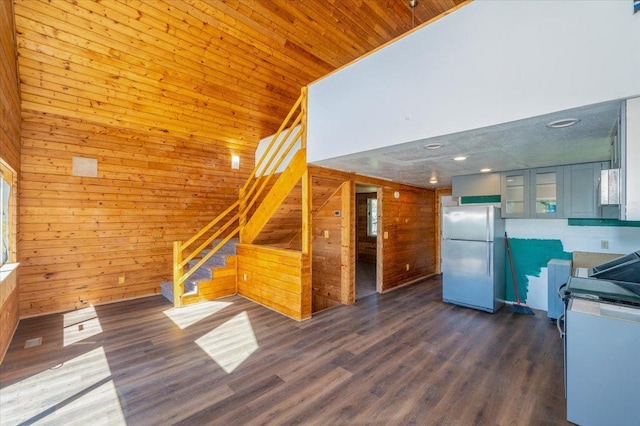 2331 Wilderness Rd, Lakeside Twp, WI 54864 - unfurnished living room with wooden walls, stairs, high vaulted ceiling, and dark wood finished floors