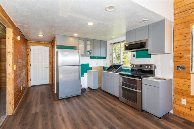 2331 Wilderness Rd, Lakeside Twp, WI 54864 - kitchen featuring stainless steel appliances, wood walls, gray cabinets, a textured ceiling, and dark wood-style flooring