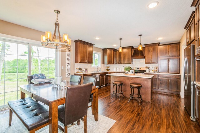 13284 288th Ave NW, Zimmerman, MN 55398 - dining space with dark wood finished floors, a chandelier, and recessed lighting