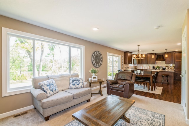13284 288th Ave NW, Zimmerman, MN 55398 - carpeted living room with plenty of natural light, baseboards, a chandelier, and recessed lighting