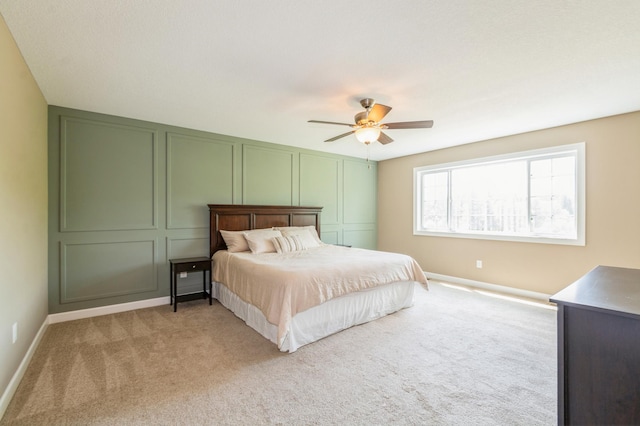13284 288th Ave NW, Zimmerman, MN 55398 - bedroom featuring a decorative wall, light carpet, baseboards, and a ceiling fan
