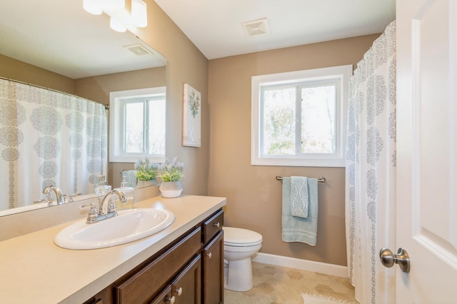 13284 288th Ave NW, Zimmerman, MN 55398 - bathroom featuring toilet, vanity, and baseboards