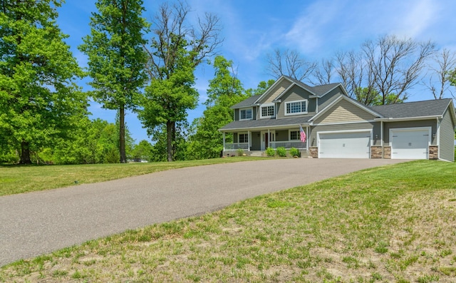 13284 288th Ave NW, Zimmerman, MN 55398 - view of front of property with a garage, asphalt driveway, covered porch, a front yard, and stone siding